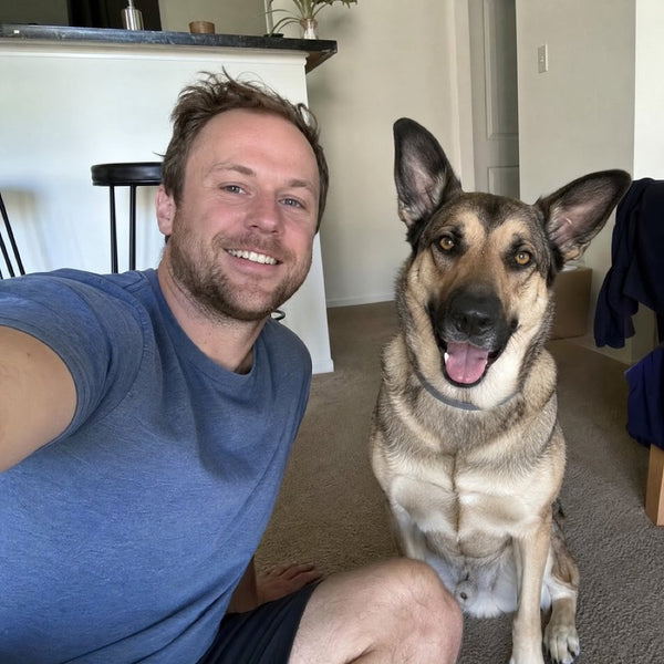 Mike T. and Bella, his German Shepherd mix in a grey CollarZen collar and their dog wearing CollarZen