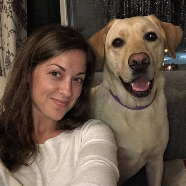 Sarah M. and Buster, her yellow Labrador in a purple CollarZen collar and their dog wearing CollarZen